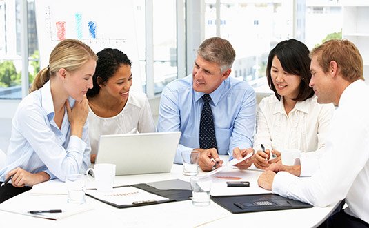 Business team in a meeting around a laptop